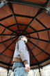 Young man under a kiosk