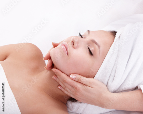 Photo: Young woman in spa. Facial massage. Young woman in spa. Facial massage.