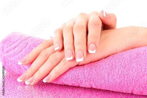 Photo: Beautiful woman hands with french manicure on pink background Beautiful woman hands with french manicure on pink background