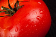 fresh ripe tomato on black