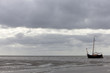 vintage sailing ship at low tide