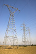 High voltage electricity pylons against blue sky High voltage electricity pylons against blue sky