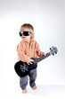 Funny little boy with ukulele guitar