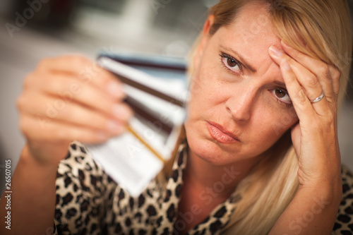 Photo: Upset Woman Glaring At Her Many Credit Cards Upset Woman Glaring At Her Many Credit Cards