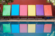 Colored sun loungers by pool Colored sun loungers by pool