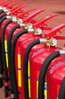 Group of ready fire extinguishers for use