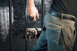 prison guard with keys walking outside dark prison cell