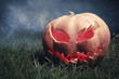 jack-o-lantern in a graveyard at night