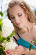 Close-up of a young woman with white flower