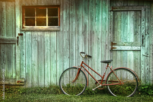 Photo: Old bicycle leaning against grungy barn Old bicycle leaning against grungy barn