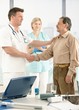 Doctor congratulating senior patient on recovery