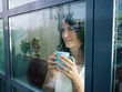 woman staring at the window
