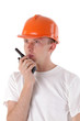builder talking on portable UHF radio transceiver isolated on wh