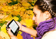 girl reading poetry of Henry Thoreau in autumn park