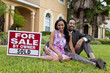 Happy African American Couple Beside House For Sale Sold Sign