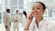 Beautiful Businesswoman on a Cellphone in an Office Lobby