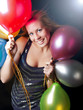 smiling woman on party holding ballons