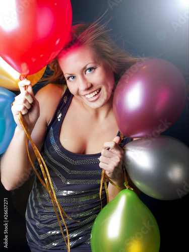 Photo: smiling woman on party holding ballons smiling woman on party holding ballons