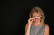Photo: smiling woman looking over glasses smiling woman looking over glasses