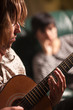 Young Musician Plays His Acoustic Guitar as Friend Listens Young Musician Plays His Acoustic Guitar as Friend Listens