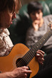 Young Musician Plays His Acoustic Guitar as Friend Listens Young Musician Plays His Acoustic Guitar as Friend Listens