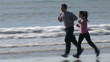 Video: Young couple running on the beach Young couple running on the beach