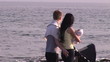 Adorable family walking by the sea in the sunset