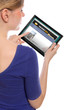 woman holding a touchpad pc and surfing the web
