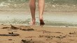 Close up of a woman in the water standing back to the beach