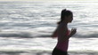 Video: Captivating woman in sportswear running on the beach Captivating woman in sportswear running on the beach