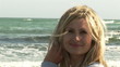 Video: Footage of a pretty woman on the beach smiling at the camera Footage of a pretty woman on the beach smiling at the camera