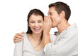 Photo: Handsome young man whispering a secret to a cute woman Handsome young man whispering a secret to a cute woman