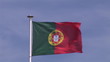 Portuguese flag in the wind with blue sky on background