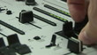 Close up of a sound engineer using his crossfader