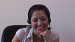 Seductive secretary talking on the phone with earpiece