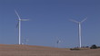 Below view of wind turbines in activity on a desert landscape
