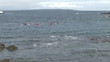 View from the beach of people doing some kayak in the sea