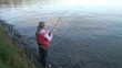Video: Rear view of a woman fishing a lake Rear view of a woman fishing a lake