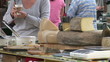 Close up of a female customer tasting melted cheese in a market