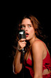 Beautiful singer singing with microphone