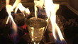 Chimney fire with glass of champagne in the foreground at night