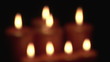 Eight blurred candles in the dark