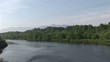 View of  a wooded lake shore during the day