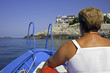Coming back at home. A woman on a motorboat coastward