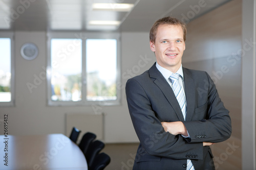 Photo: Young business man in a meeting room Young business man in a meeting room