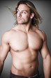 Muscular man measuring his waist