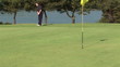 Male golfer missing the hole during competition