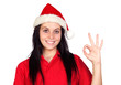 Happy girl with Christmas hat saying Ok