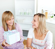 Beautiful woman receiving a present during a birthday party Beautiful woman receiving a present during a birthday party
