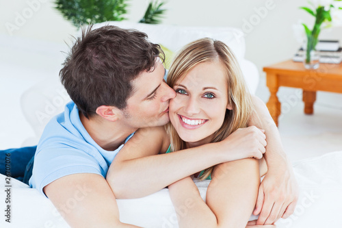 Photo: Portrait of an attentive man kissing his girlfriend at home Portrait of an attentive man kissing his girlfriend at home